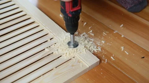 Close-up of electric drill making hole in wooden board. Clean woodworking scene Vídeo Stock 311981024
