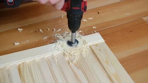 Close-up of electric drill making hole in wooden board Stock Footage 337297947