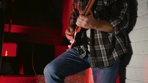 Close-up of Electric Guitar Player with Dramatic Red Lighting. Musician han.. Stock Footage 331971316