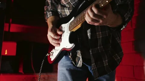 Close-up of Electric Guitar Player with Dramatic Red Lighting. Musician han.. Stock Footage 331971317