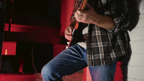 Close-up of Electric Guitar Player with Dramatic Red Lighting. Musician han.. Stock Footage 331971324