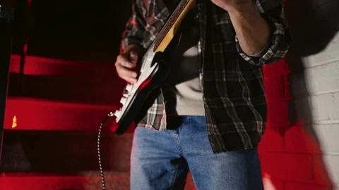 Close-up of Electric Guitar Player with Dramatic Red Lighting. Musician han.. Stock Footage 331971330