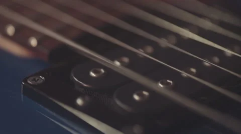 Close Up of Electric Guitar String Being Picked Vibrating near pickup Stock Footage 64622368