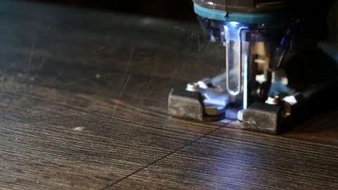 Close-up of electric jigsaw in action. Cutting board. Stock Footage 85370180