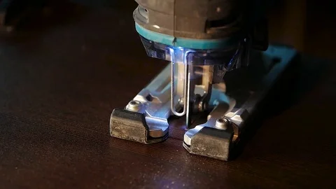 Close-up of electric jigsaw in action. Cutting board. Manufacturing of furniture Stock Footage 85370220
