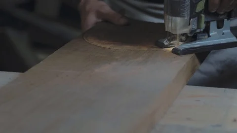 Close-up of electric jigsaw in action. Cutting board. Man with electric jigsaw Stock Footage 119051637