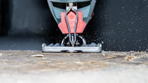 Close up electric jigsaw cutting a piece of wood Stock Photos