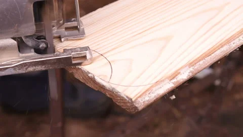 Close-up of electric jigsaw in the process of operation. Home workshop. Stock Footage 128449097