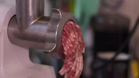 Close-Up of Electric Meat Grinder Producing Ground Meat Stock-Footage 334123623