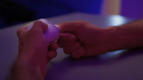 Close-up of an electric nail clipper in hand, modern personal care technology Stock Footage 312902652