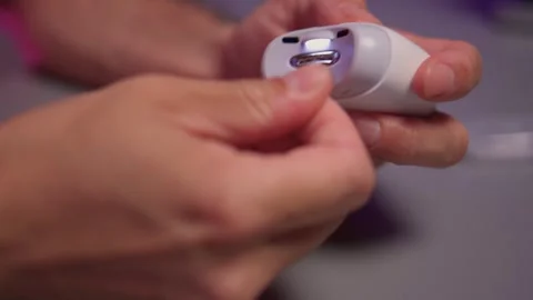 Close-up of an electric nail clipper in hand, modern personal care technology Stock Footage 312902654