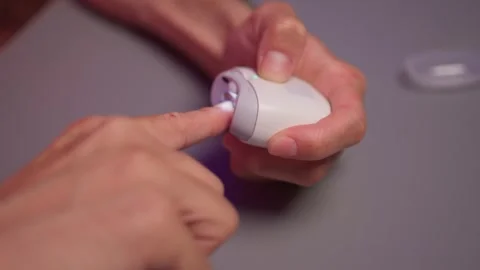 Close-up of an electric nail clipper in hand, modern personal care technology Stock Footage 312902701