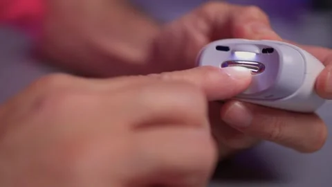 Close-up of an electric nail clipper in hand, modern personal care technology Stock Footage 312902709