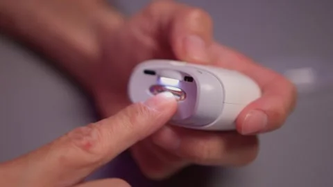 Close-up of an electric nail clipper in hand, modern personal care technology Stock Footage 312902905