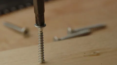 Close up of electric screw driver drilling out screw of wooden board Stock Footage 261129212