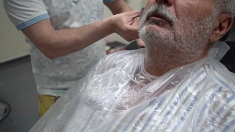 Close up of electric shaver being in hands of a barber 스톡 동영상 133563866