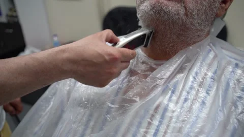 Close up of electric shaver being in hands of a barber 스톡 동영상 133563968