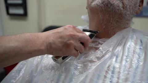 Close up of electric shaver being in hands of a barber 스톡 동영상 133564219