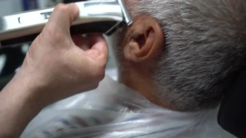 Close up of electric shaver being in hands of a barber 스톡 동영상 133564342