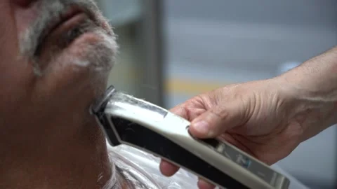Close up of electric shaver being in hands of a barber Stock Footage 133564373