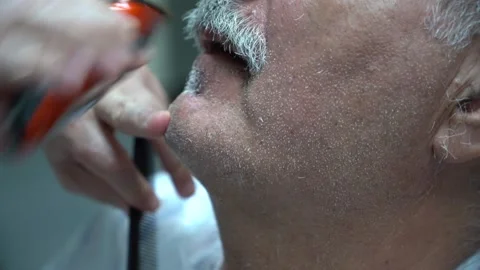 Close up of electric shaver being in hands of a barber 스톡 동영상 133564443