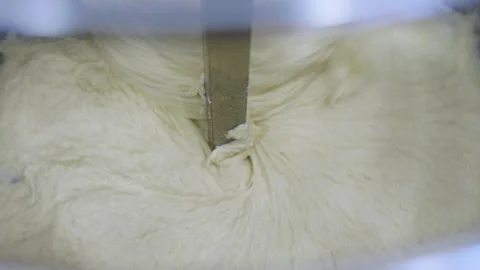 Close-up in an electric spiral kneading machine for kneading dough Stock Footage 280584499