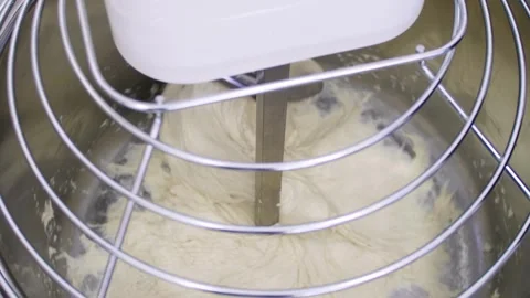 Close-up in an electric spiral kneading machine for kneading dough Stock Footage 280584568