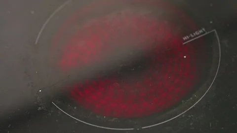 Close up of electric stove heating surface before placing frying pan with bread Stock Footage 318124789