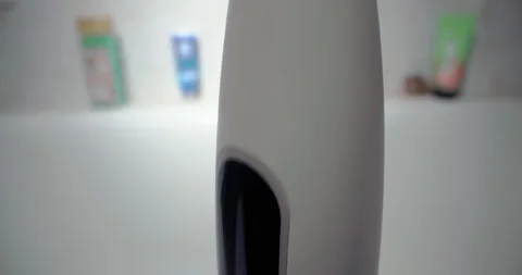 Close-Up of Electric Toothbrush in Bathroom: Daily Dental Care and Hygiene Video stock 252171889