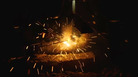 Close-up of electric welder's work in dark room. Bright flames, smoke and sparks Stock Footage 203665846