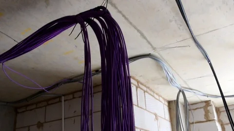 Close up of electrical cables hanging down in new build Stock Footage 112615057