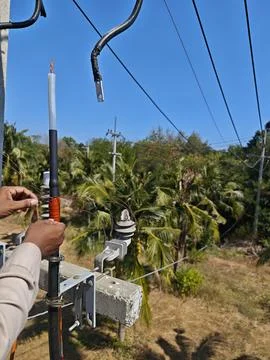 Close up of electrical lineman hands preparing copper shield wires. Stock Photos