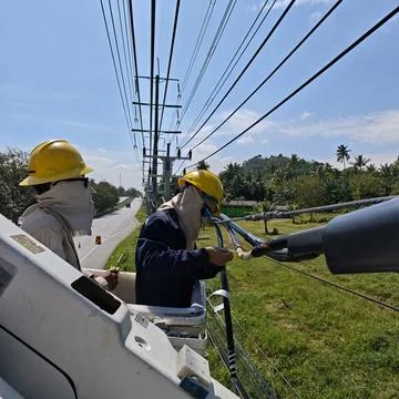 Close up of electrical lineman technician hands connecting copper wire. Stock Photos
