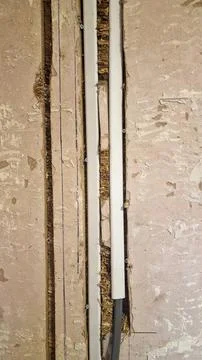 Close up of electrical wires being installed in a plaster wall Stock Photos