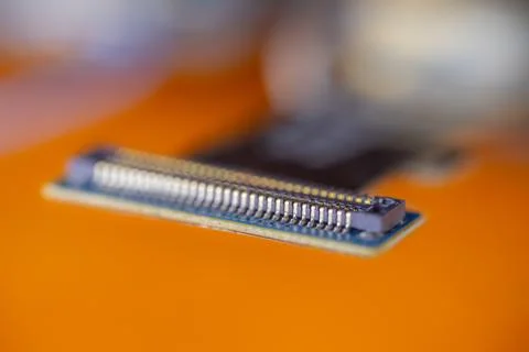 Close up electronic circuit connector with rows of metal contacts and blue .. Stock-Fotos