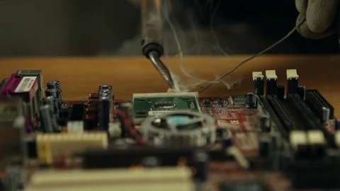 Close up of an electronics engineer soldering an electric board. Video stock 88365249