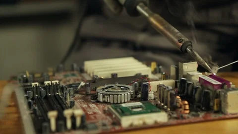 Close up of an electronics engineer soldering an electric board. Stock Footage 88366637