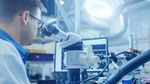 Close Up of an Electronics Factory Worker in White Work Coat Soldering Board Stock Footage 98727325
