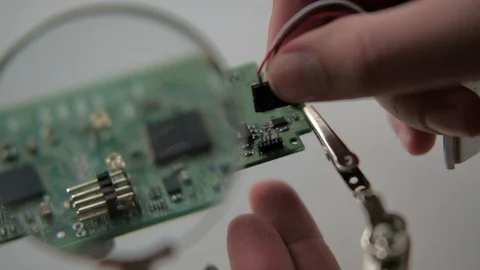Close-up Electronics repair soldering microchips and circuit boards at computers Stock Footage 90049319