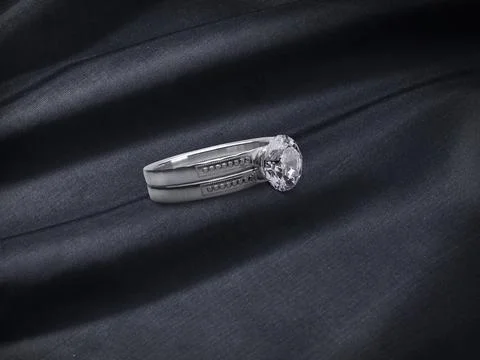 Close up of elegant diamond ring on black fabric background Stock Photos