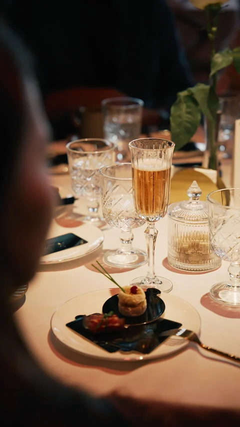 Close up of elegant dining table with appetizer and glass of sparkling wine Stock Footage 345265481