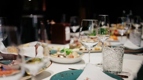 Close-up of elegant dining table setup with sparkling empty wine glasses, v.. Stock Footage 339643887