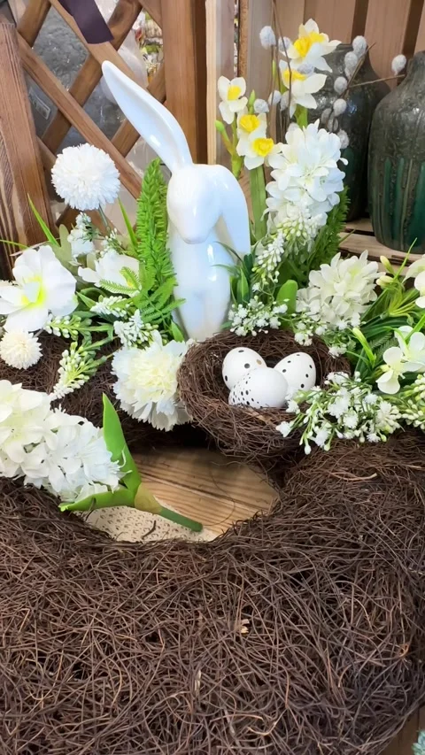 A close-up of an elegant Easter wreath with a ceramic bunny, delicate white and Stock Footage 313005536