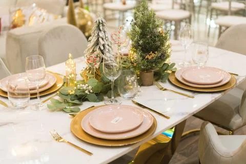 Close-up of an elegant festive table with warm decorations and Christmas li.. Stock Photos
