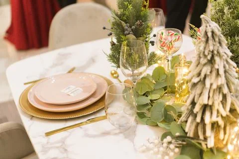 Close-up of an elegant festive table with warm decorations and Christmas li.. Stock Photos