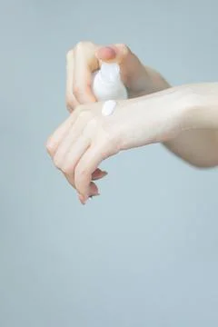 Close up of elegant hands applying cream Stock Photos