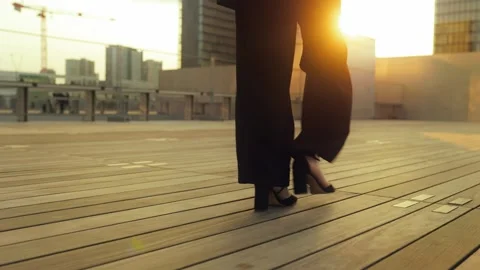 Close-up of elegant high heels as a confident businesswoman walks at sunset Stock Footage 311452500