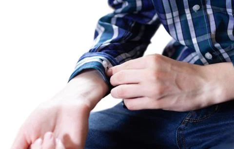 Close-up of an elegant man's hand buttoning his shirt cuff Stock Photos