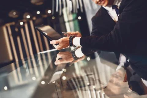 Close up of elegant men pointing to the screen of the tablet Stock Photos