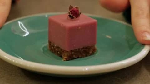 Close-up of an elegant pink dessert with a smooth creamy texture, placed on a Stock-Footage 302567487